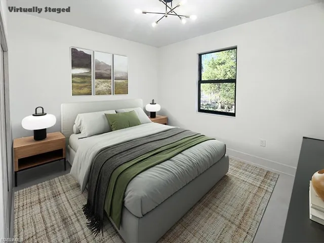 Bedroom with a chandelier and baseboards