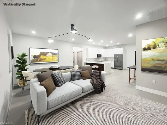 Living area featuring recessed lighting and concrete flooring