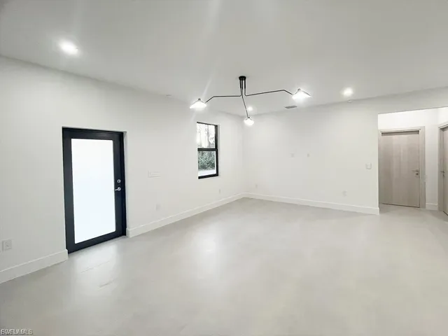 Spare room featuring recessed lighting and finished concrete floors