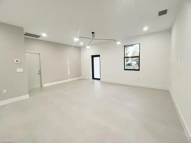 Spare room with finished concrete floors and recessed lighting
