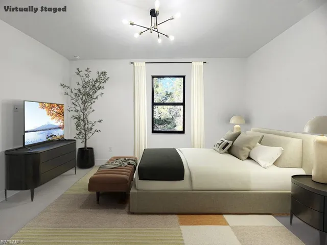 Carpeted bedroom featuring a chandelier