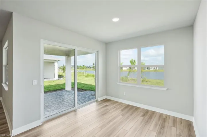 Unfurnished room with light wood-type flooring and a water view