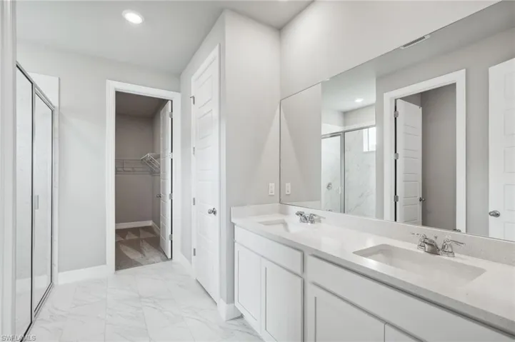 Bathroom featuring walk in shower and vanity