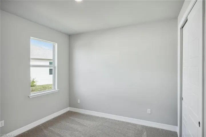 Empty room with carpet flooring