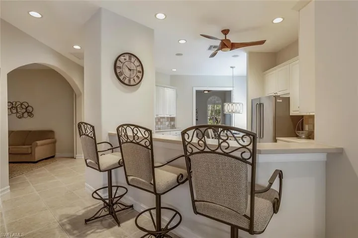 Dining room with ceiling fan and light tile patterned flooring