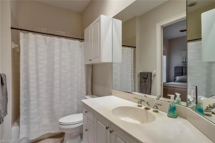Bathroom with vanity, tile patterned floors, and toilet