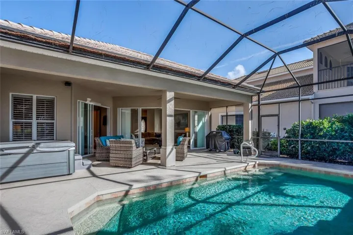 View of pool featuring grilling area, an outdoor living space, a lanai, and a patio area