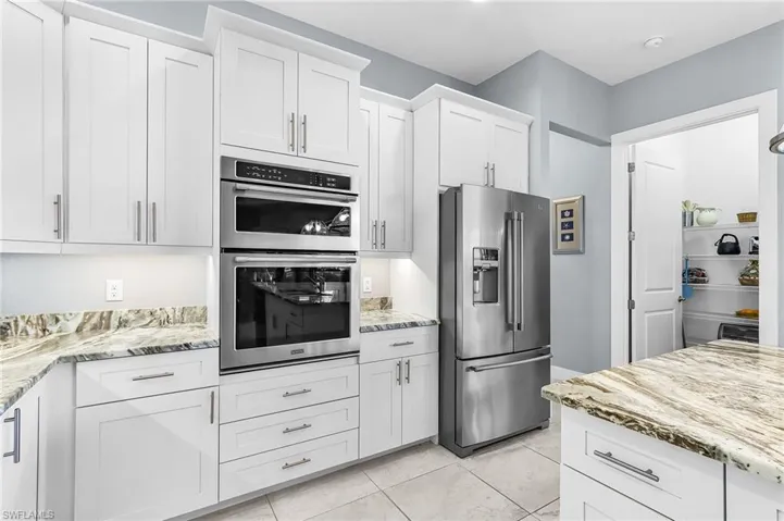 very large kitchen, stainless steel appliances, seating for 6 around large island, walk-in pantry
