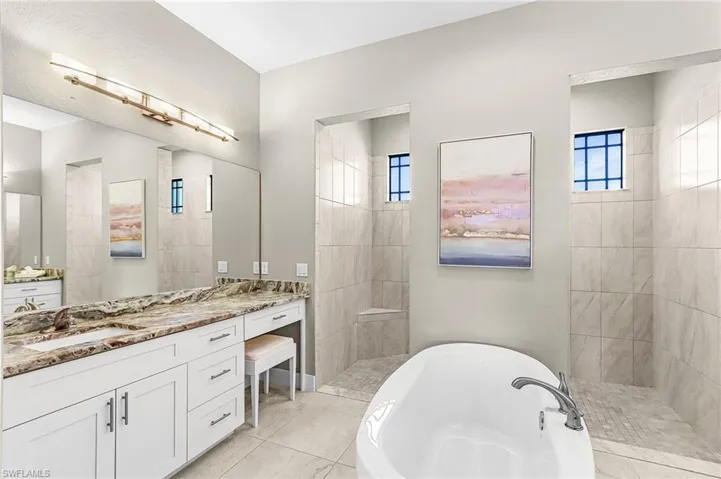 dual vanities, soaking tub, private toilet, large storage closet, large walk-in shower