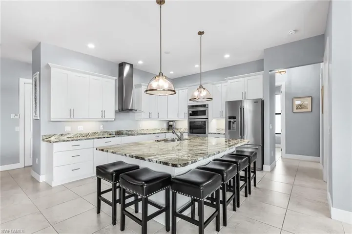 large island with seating for 6, soft close, stainless steel appliances, open floor plan, view of pool and lanai