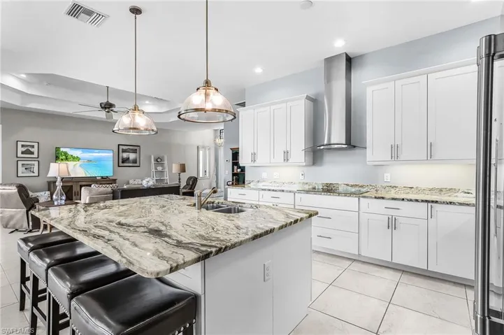 large island with seating for 6, soft close, stainless steel appliances, open floor plan, view of pool and lanai