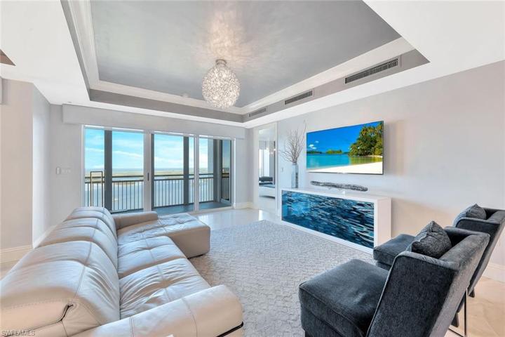 The living room's sliding glass doors have electric, remote-controlled shades.