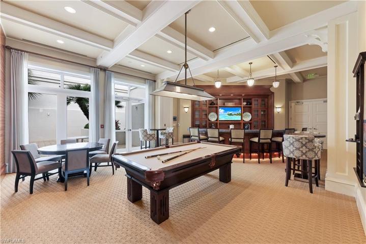 The billiards room is perfect for entertaining a small group with the pool table, poker table, tv and private patio.