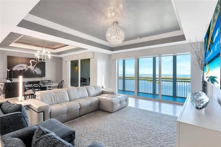 Sliding glass doors span across the living and dining areas, providing an abundance of natural light and access to the lanai.