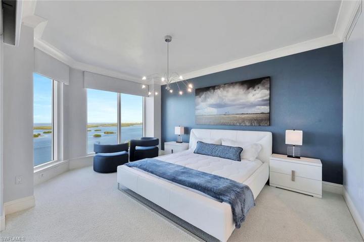 The main bedroom features floor to ceiling picture windows that frame the amazing views of the bay and gulf.