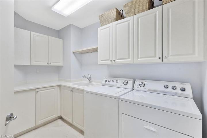 The residence has a laundry room with tub and ample cabinetry for additional storage.