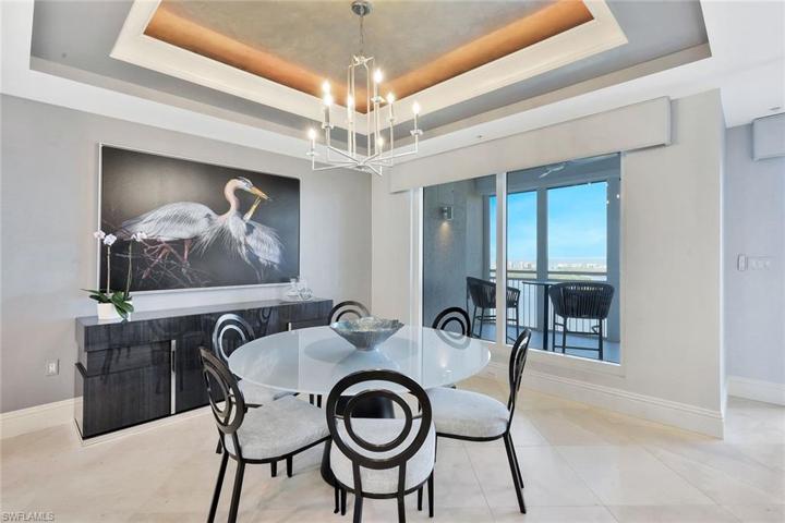 The dining area has the beautiful marble flooring, tasteful Coastal decor, and beautiful views.