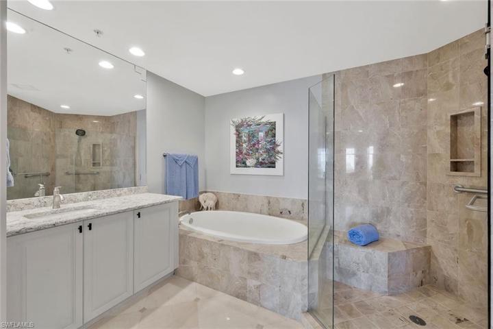 The main bedroom has an en-suite bathroom with beautiful marble flooring, raised vanities with quartz countertops and dual sinks, a huge soaking tub and spacious shower.