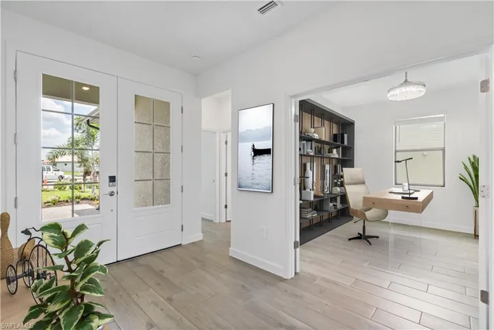 Entrance foyer with plenty of natural light and wood style flooring