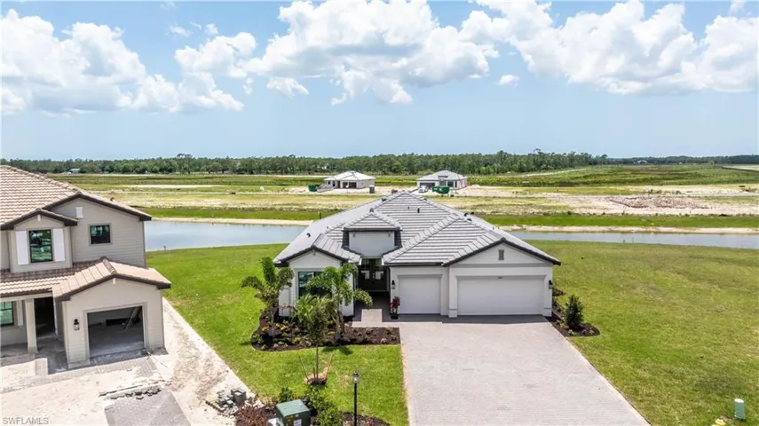 View of front of home featuring a front yard and a water view