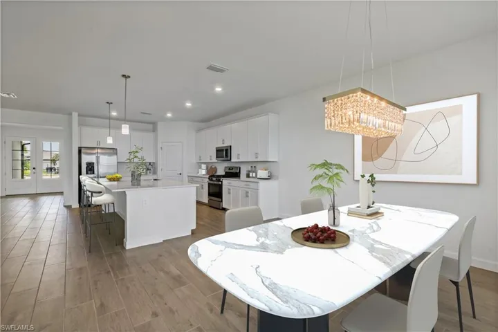 Dining room featuring wood style flooring and a chandelier