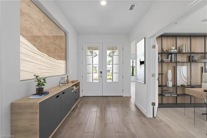 Entryway with french doors and wood style flooring