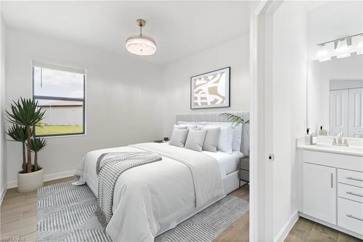 Bedroom with en-suite bathroom and wood style floors