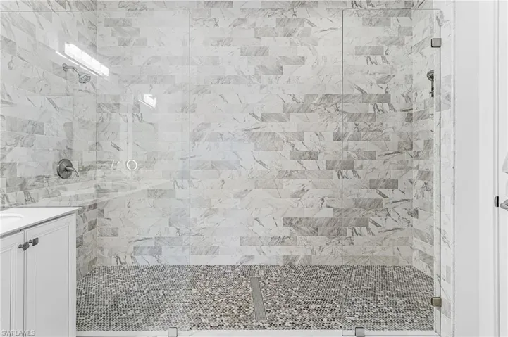 Bathroom featuring a stall shower and vanity