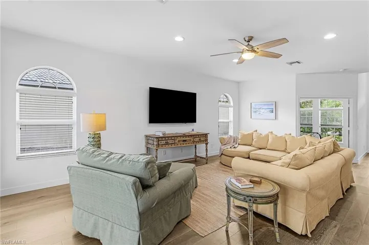 Living room featuring recessed lighting, a ceiling fan, and light wood-type flooring