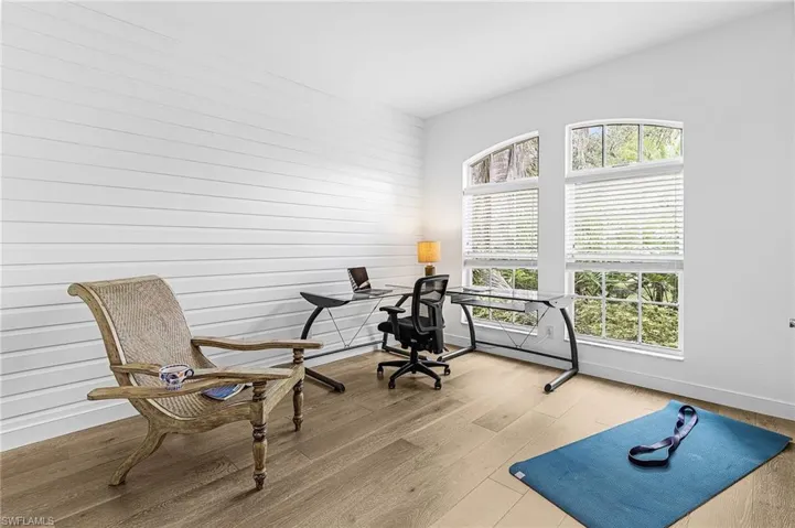 Exercise room featuring wood finished floors and wood walls