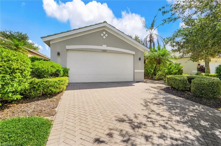 Garage featuring decorative driveway