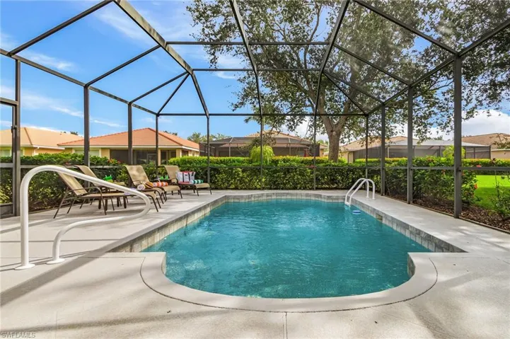 Outdoor pool featuring a patio area, a sunroom, and glass enclosure