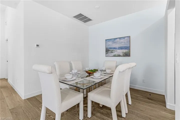 Dining room featuring light wood-style flooring and baseboards