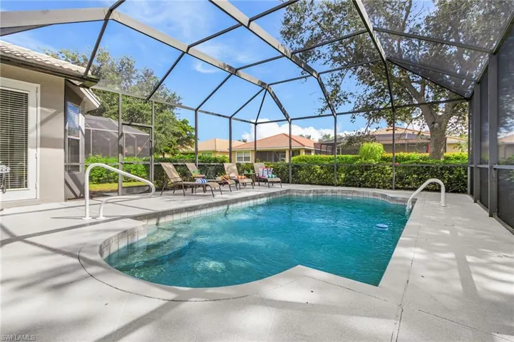 Swimming pool with a sunroom, a patio, and a lanai