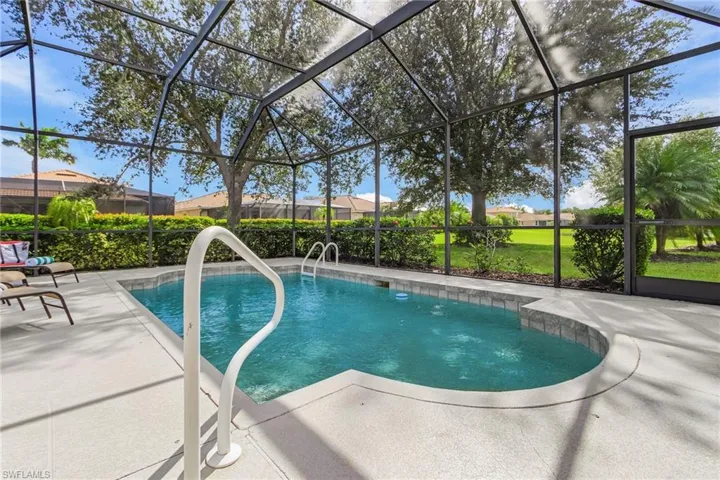 Swimming pool featuring a sunroom, glass enclosure, and a patio