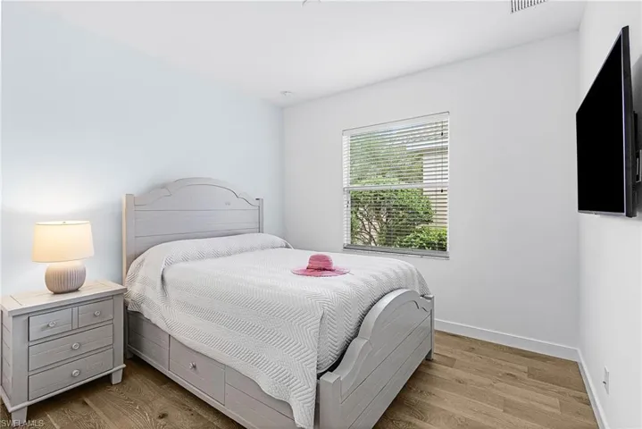 Bedroom featuring wood finished floors and baseboards