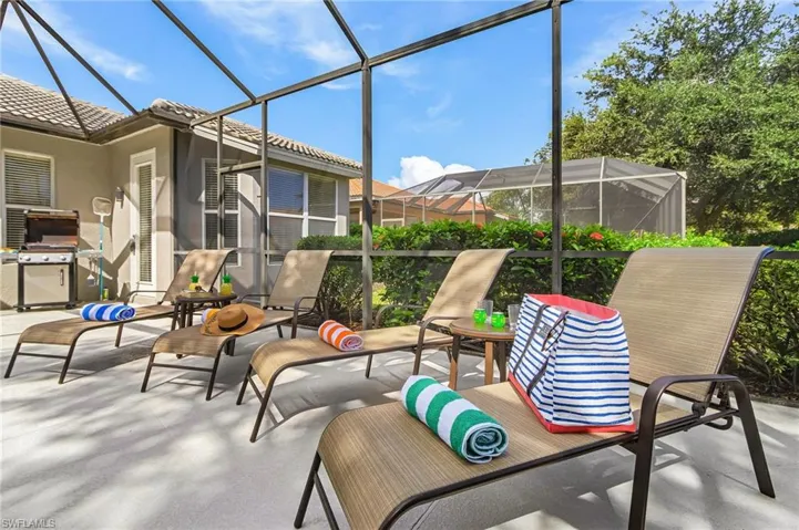View of patio featuring a lanai, a sunroom, and a grill