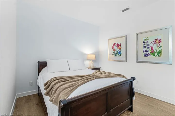 Bedroom featuring wood finished floors and baseboards