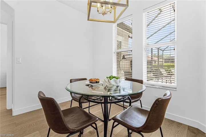 Dining area featuring light wood-type flooring and a chandelier