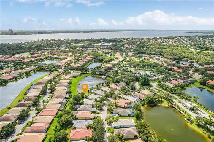 Aerial perspective of suburban area featuring a large body of water