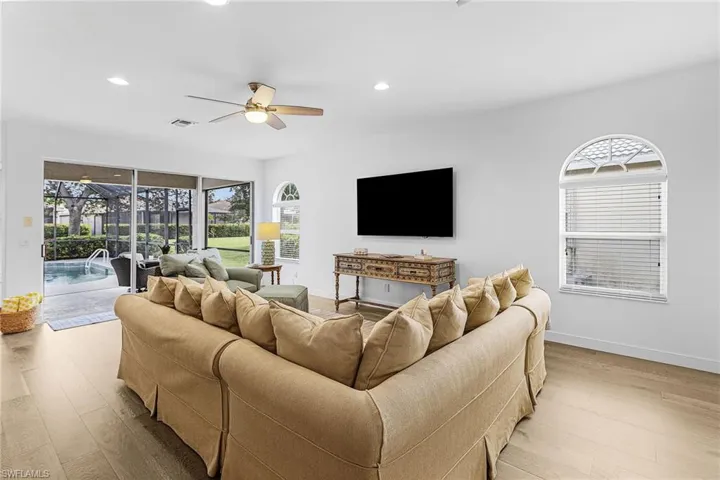 Living room with recessed lighting, light wood-style flooring, a ceiling fan, and a sunroom