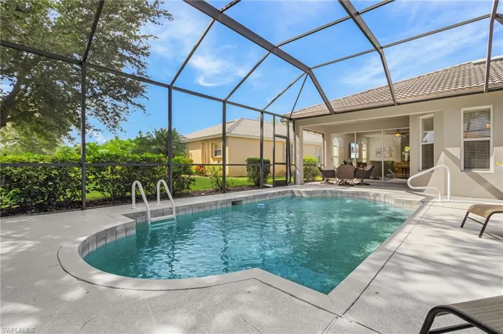 Outdoor pool featuring a sunroom, a patio area, a lanai, and ceiling fan