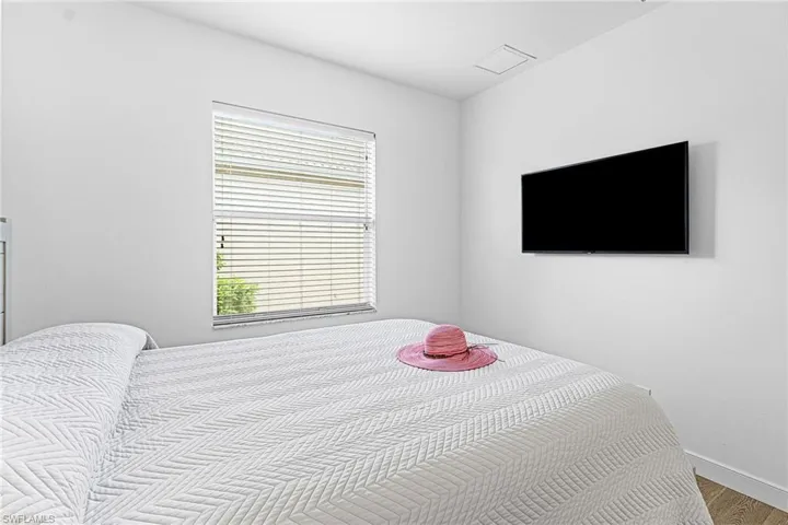 Bedroom with wood finished floors and baseboards