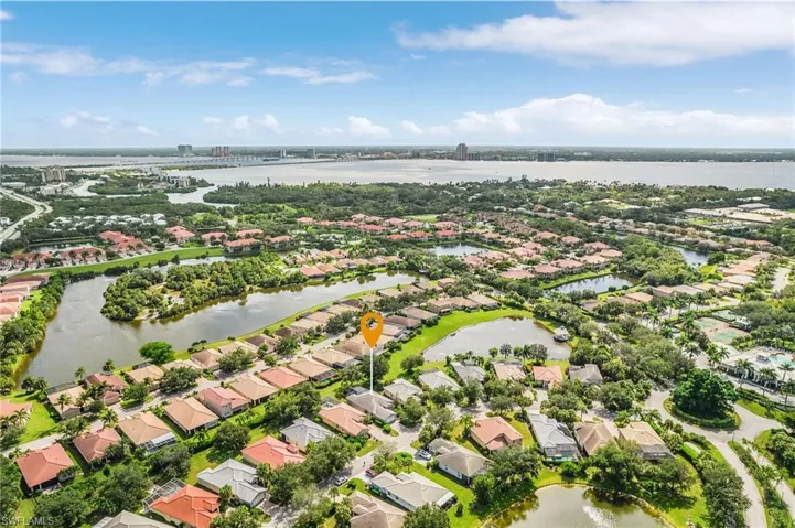 Aerial view of property's location with a large body of water and nearby suburban area