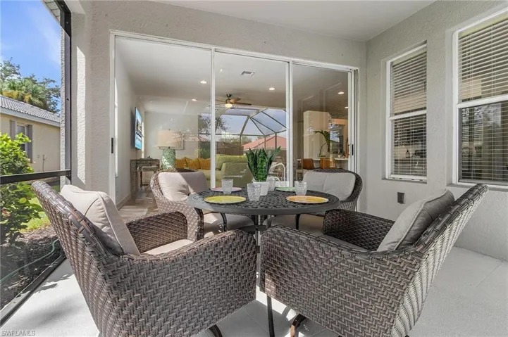 Sunroom / solarium with outdoor dining area and a ceiling fan