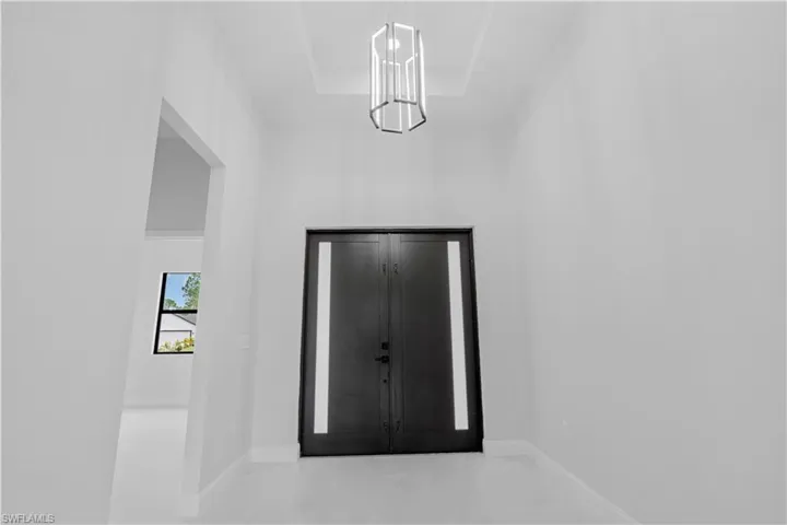 Entrance foyer featuring baseboards and a raised ceiling