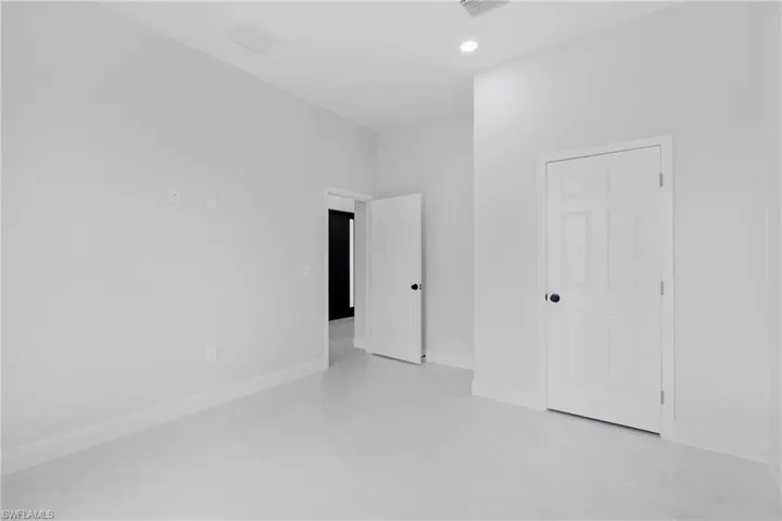 Unfurnished bedroom with baseboards and recessed lighting