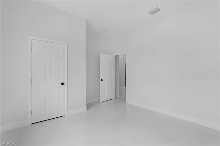 Unfurnished room with baseboards