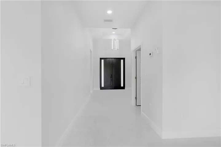 Hallway featuring baseboards and recessed lighting