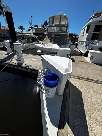 Dockside setting with a concrete surface and wooden pilings